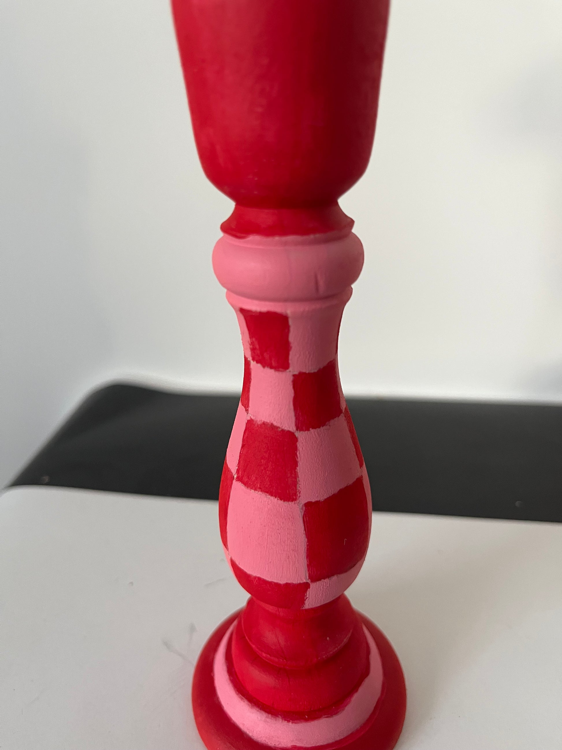 Close-up of a red and white checkered object on a light gray background